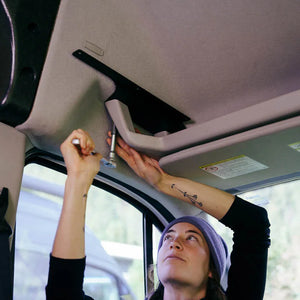 final installation of ford transit bracket for headliner shelf using 7mm socket and wrench