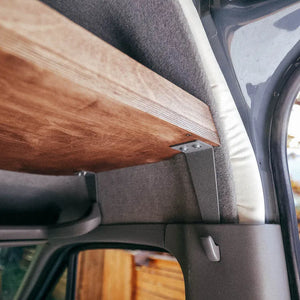 DIY headliner shelf mounted to mercedes coathook and grab bar to create overhead storage above the driver and passenger seats